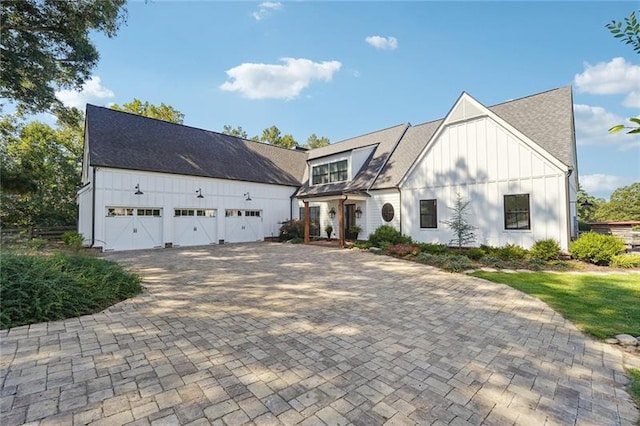 3842 Ernest W Barrett Pkwy SW, Marietta, GA 30064 - view of front facade featuring board and batten siding, a garage, and a shingled roof