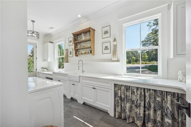 3842 Ernest W Barrett Pkwy SW, Marietta, GA 30064 - kitchen with a sink, dark marble finish flooring, white cabinetry, washer / dryer, and light countertops