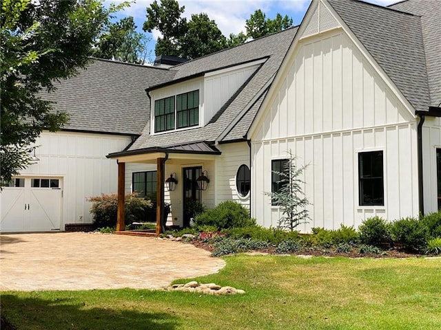3842 Ernest W Barrett Pkwy SW, Marietta, GA 30064 - modern farmhouse with board and batten siding, a shingled roof, a front lawn, and a standing seam roof