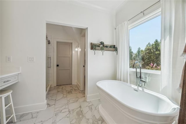 3842 Ernest W Barrett Pkwy SW, Marietta, GA 30064 - bathroom featuring marble look tiles, baseboards, a freestanding tub, a stall shower, and vanity