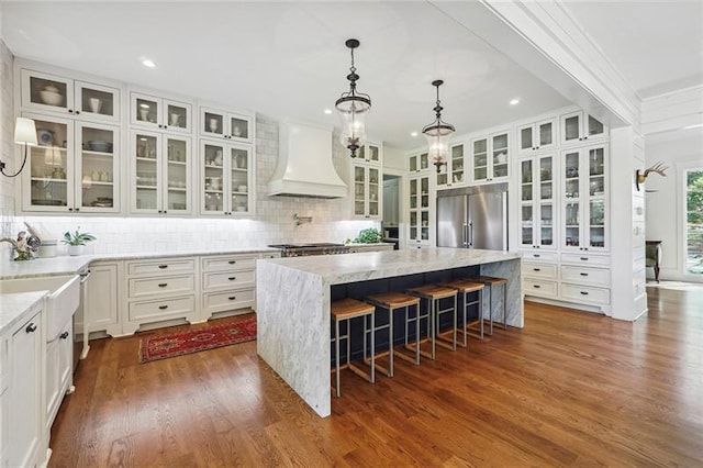 3842 Ernest W Barrett Pkwy SW, Marietta, GA 30064 - kitchen featuring custom exhaust hood, stainless steel appliances, white cabinets, a center island, and dark wood-type flooring