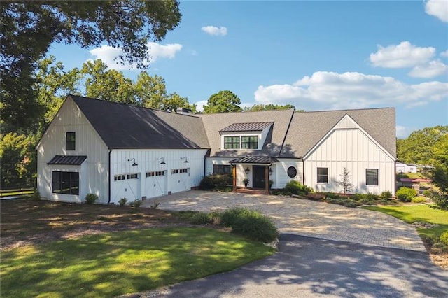 3842 Ernest W Barrett Pkwy SW, Marietta, GA 30064 - modern farmhouse style home with board and batten siding, driveway, a garage, and a standing seam roof