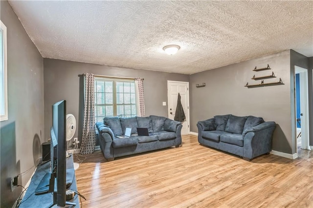 504 J C Daniel Rd, Carrollton, GA 30117 - living area featuring wood finished floors, a textured ceiling, and baseboards