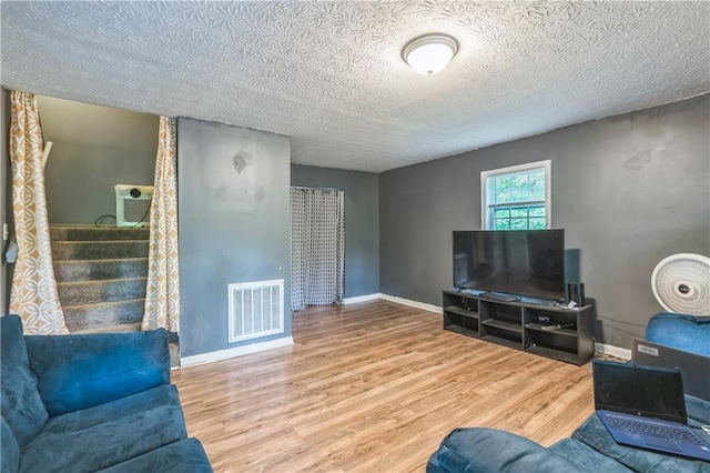 504 J C Daniel Rd, Carrollton, GA 30117 - living area with wood finished floors, a textured ceiling, and baseboards