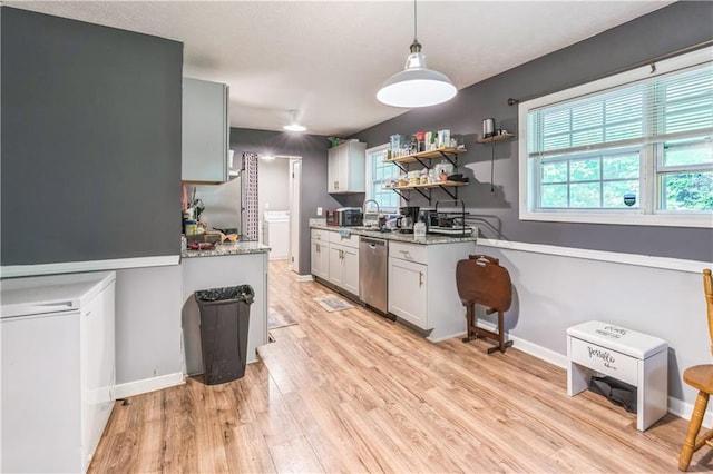 504 J C Daniel Rd, Carrollton, GA 30117 - kitchen featuring stainless steel dishwasher, plenty of natural light, light wood-type flooring, and light stone countertops