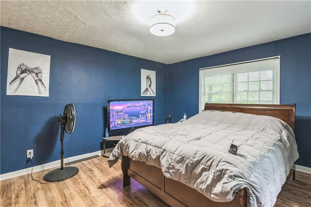 504 J C Daniel Rd, Carrollton, GA 30117 - bedroom featuring wood finished floors, baseboards, and a textured ceiling