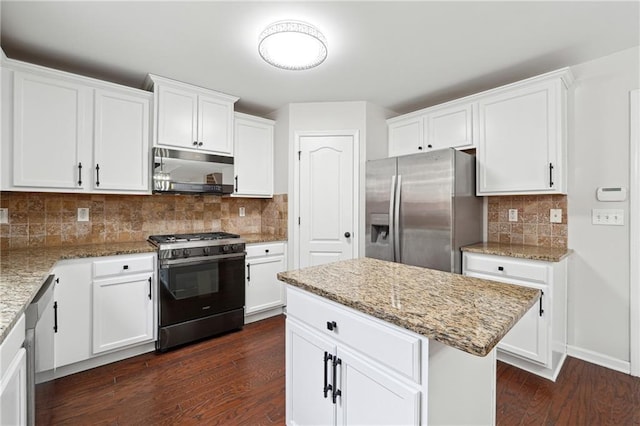 kitchen featuring white cabinetry, black range with gas stovetop, stainless steel fridge, a center island, and light stone counters