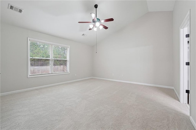 unfurnished room with ceiling fan, light colored carpet, and lofted ceiling