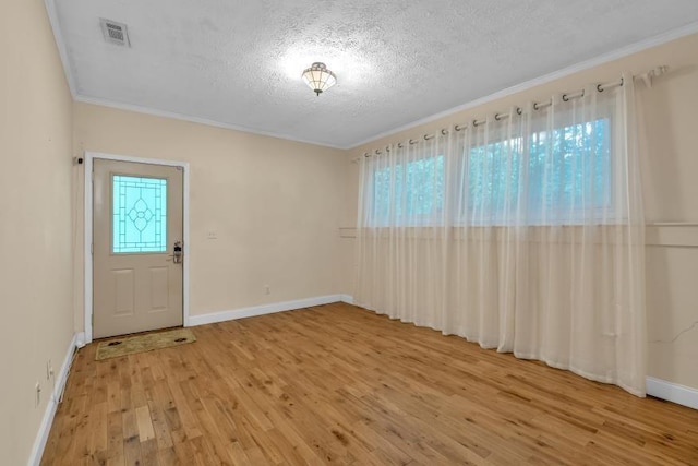 481 Patillo Rd, Stockbridge, GA 30281 - foyer entrance featuring a textured ceiling, light wood-type flooring, crown molding, and baseboards
