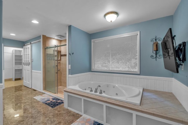 481 Patillo Rd, Stockbridge, GA 30281 - full bath with a stall shower, a wainscoted wall, a spacious closet, a tub with jets, and recessed lighting