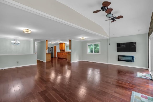 481 Patillo Rd, Stockbridge, GA 30281 - unfurnished living room with ceiling fan, a chandelier, baseboards, a glass covered fireplace, and dark wood-type flooring