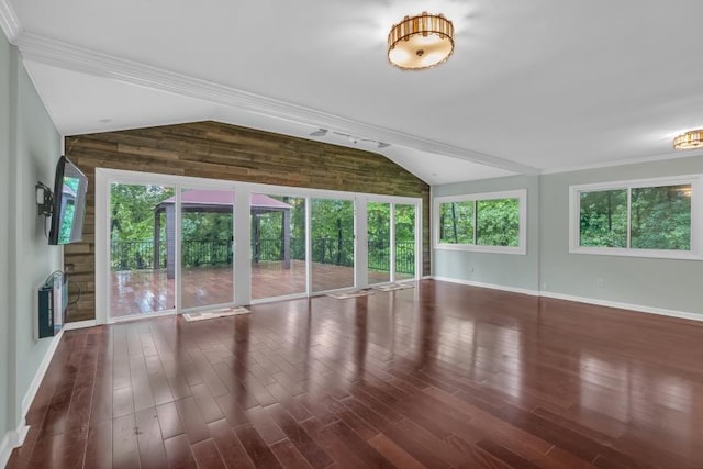 481 Patillo Rd, Stockbridge, GA 30281 - unfurnished living room with vaulted ceiling, baseboards, heating unit, dark wood finished floors, and wood walls