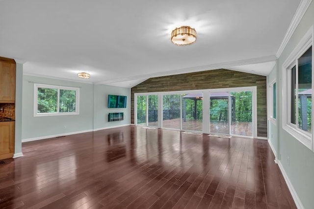 481 Patillo Rd, Stockbridge, GA 30281 - unfurnished living room featuring lofted ceiling, crown molding, baseboards, and dark wood-style floors