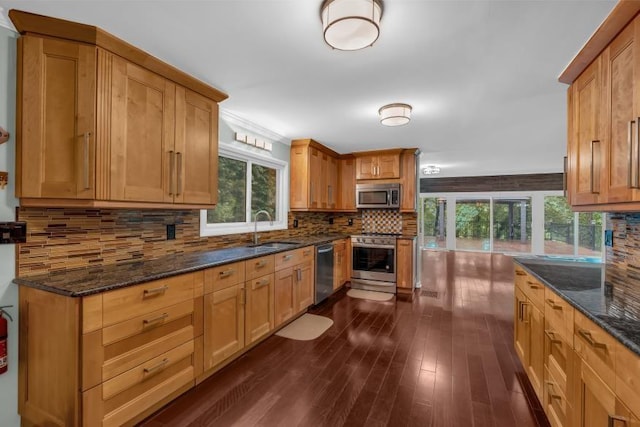 481 Patillo Rd, Stockbridge, GA 30281 - kitchen with appliances with stainless steel finishes, dark wood-style floors, backsplash, a sink, and healthy amount of natural light