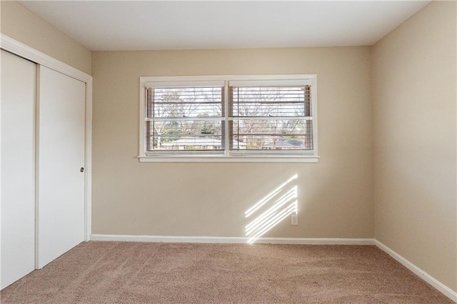 2473 Tyler Way, Decatur, GA 30032 - unfurnished bedroom featuring a closet, light carpet, and multiple windows