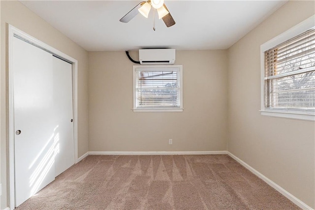2473 Tyler Way, Decatur, GA 30032 - unfurnished bedroom featuring ceiling fan, a wall unit AC, light colored carpet, and a closet