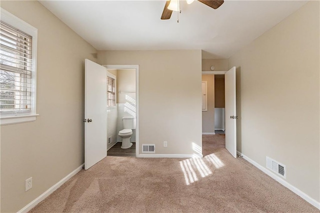 2473 Tyler Way, Decatur, GA 30032 - unfurnished bedroom featuring multiple windows, carpet floors, ceiling fan, and ensuite bath