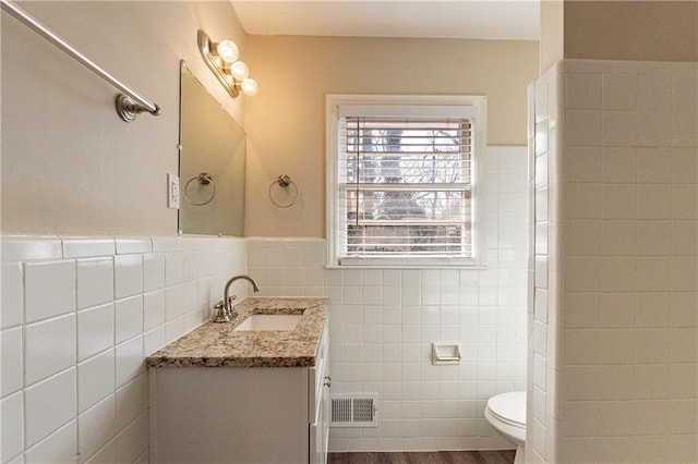2473 Tyler Way, Decatur, GA 30032 - bathroom featuring vanity, toilet, hardwood / wood-style floors, and tile walls