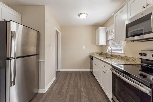 2473 Tyler Way, Decatur, GA 30032 - kitchen with white cabinetry, stainless steel appliances, light stone countertops, and sink