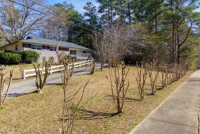 view of yard featuring a fenced front yard and driveway