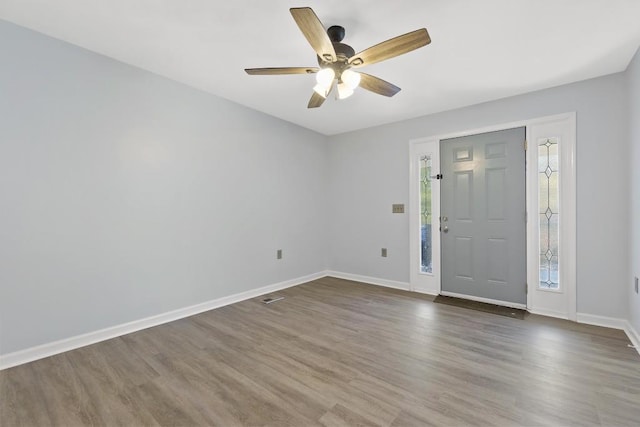 entryway with a ceiling fan, baseboards, and wood finished floors