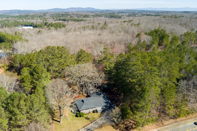 birds eye view of property with a forest view and a mountain view