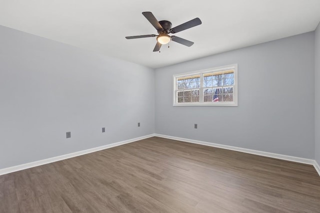 unfurnished room with ceiling fan, baseboards, and wood finished floors