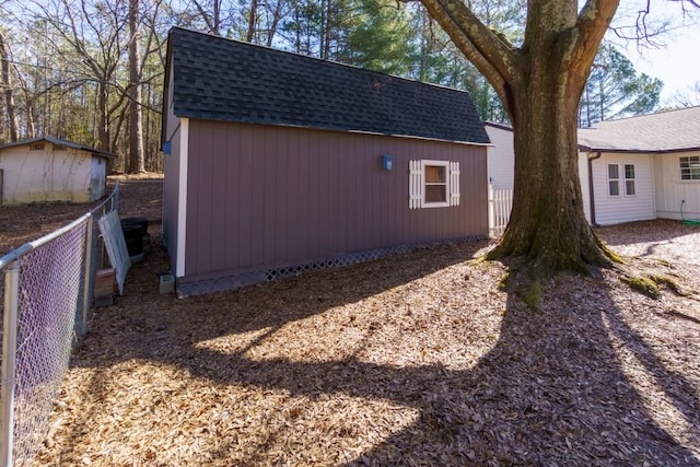 view of yard with fence and an outbuilding