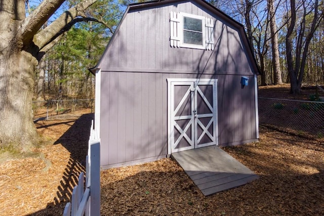 view of barn with fence