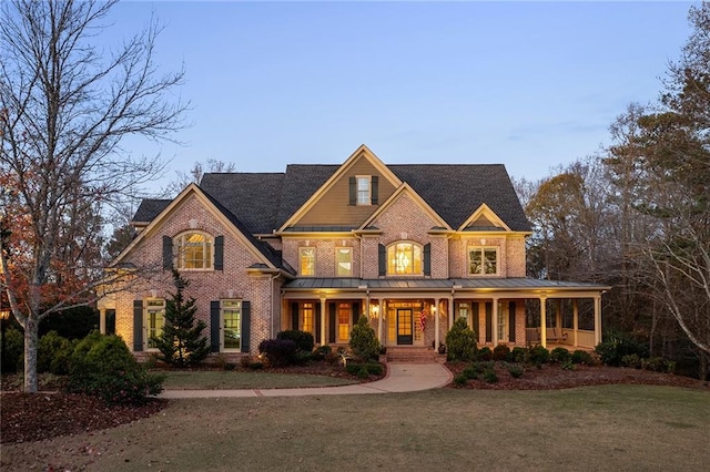 view of front facade with a front yard and a porch