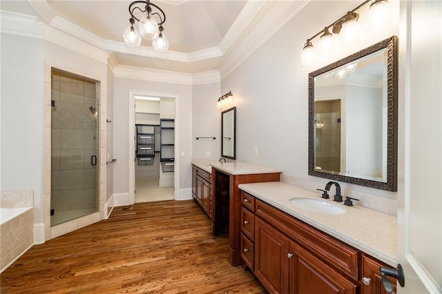 bathroom featuring hardwood / wood-style flooring, vanity, separate shower and tub, and crown molding