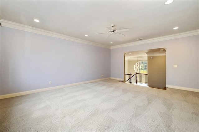 carpeted spare room featuring ceiling fan and ornamental molding