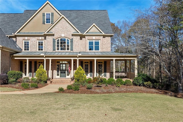 craftsman house featuring covered porch and a front yard