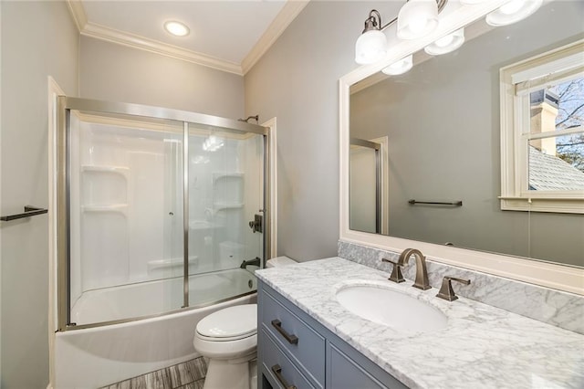 full bathroom with ornamental molding, bath / shower combo with glass door, toilet, vanity, and hardwood / wood-style flooring