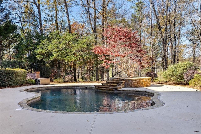 view of pool with a patio and a hot tub