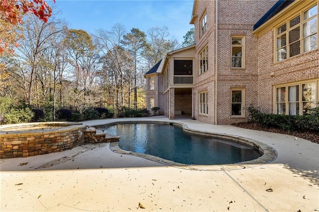 view of swimming pool with a patio area and an in ground hot tub