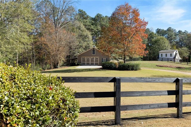 view of gate with an outbuilding and a yard