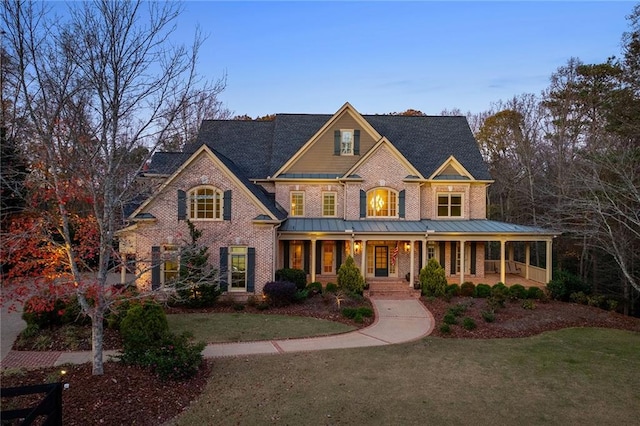 view of front facade featuring covered porch and a front lawn