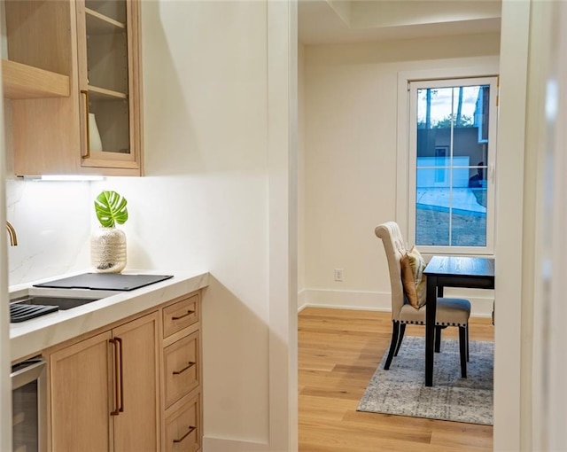 dining area featuring light wood finished floors and baseboards