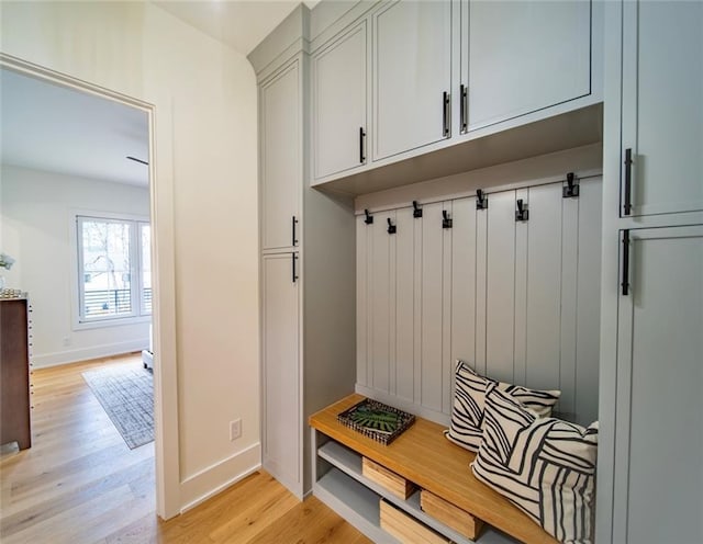 mudroom with baseboards and light wood-type flooring