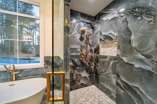 full bath with a soaking tub, tile walls, and a shower
