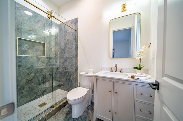 full bath with vanity, toilet, and a marble finish shower