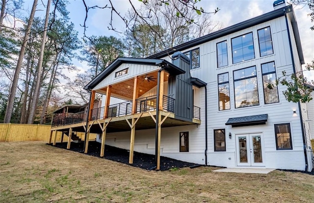 rear view of house with a ceiling fan, fence, a yard, french doors, and a wooden deck