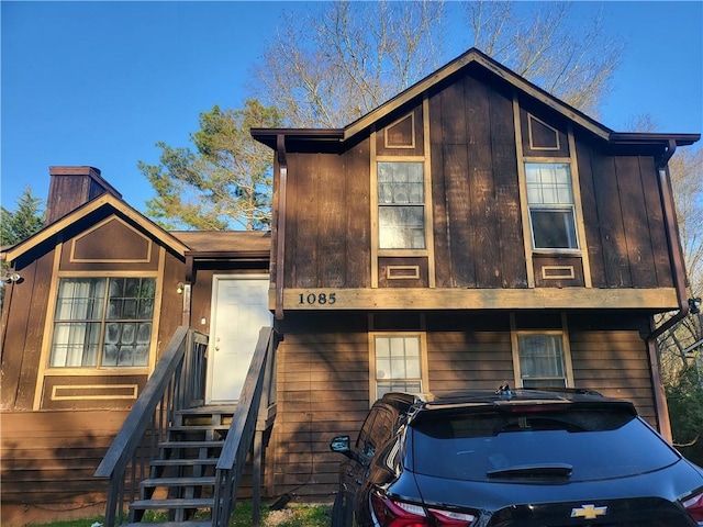 rustic home with board and batten siding and entry steps