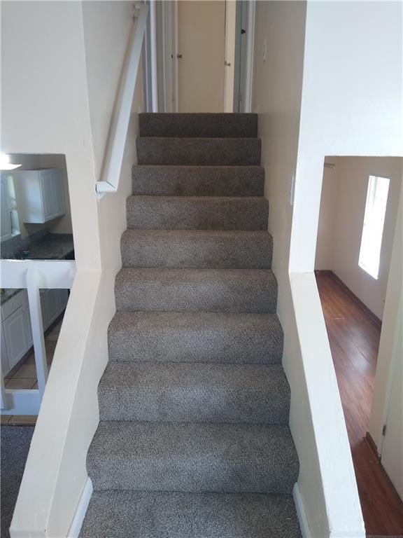 stairway featuring wood finished floors