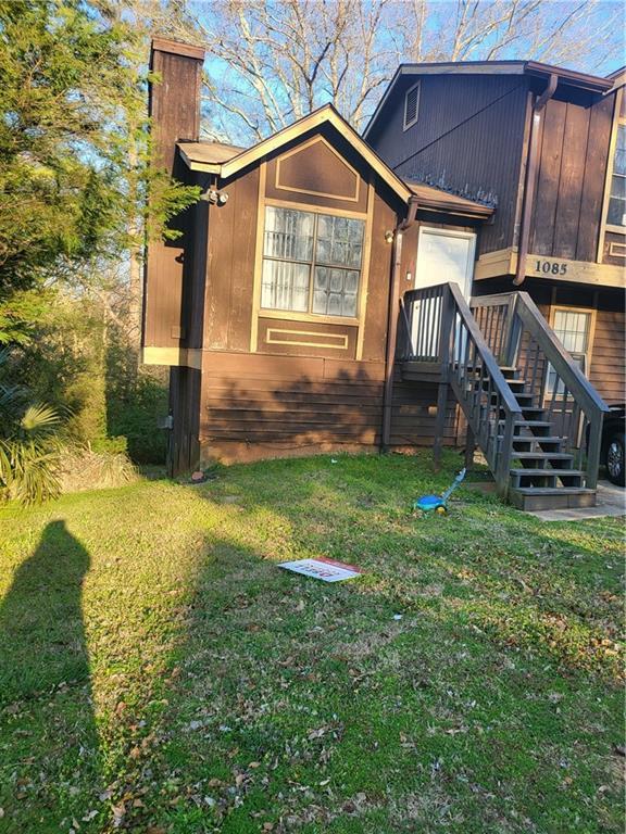 exterior space with a yard and a chimney