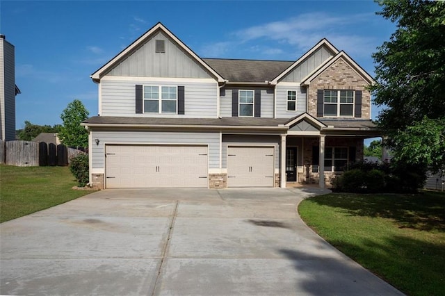 9120 Alden Dr, Locust Grove, GA 30248 - view of front facade featuring board and batten siding, a garage, driveway, covered porch, and stone siding