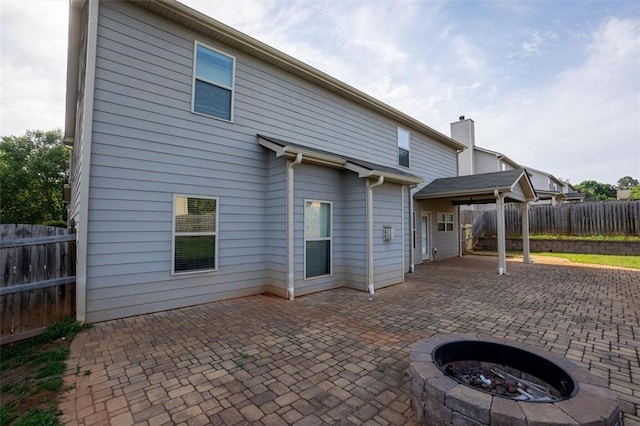 9120 Alden Dr, Locust Grove, GA 30248 - back of house featuring a patio area, an outdoor fire pit, and a fenced backyard