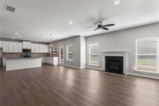 9120 Alden Dr, Locust Grove, GA 30248 - unfurnished living room featuring recessed lighting, healthy amount of natural light, baseboards, and a ceiling fan