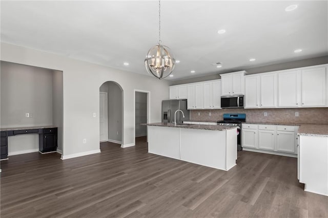 9120 Alden Dr, Locust Grove, GA 30248 - kitchen with stainless steel appliances, arched walkways, a chandelier, tasteful backsplash, and white cabinetry